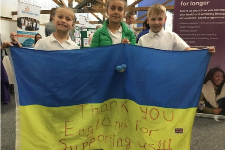 Children holding Ukrainian flag