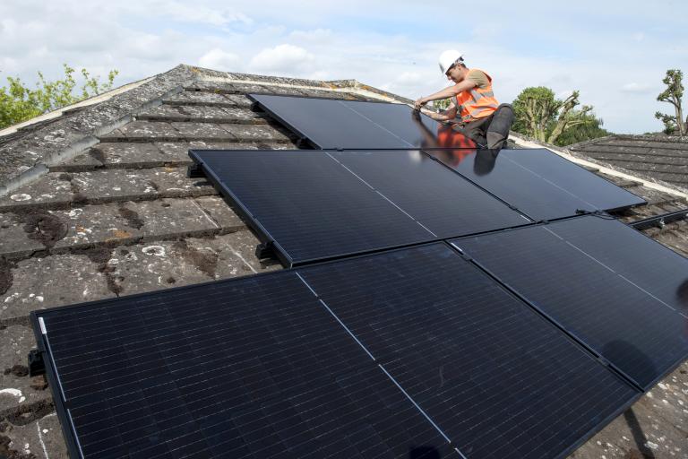 Solar panels being installed on a roof