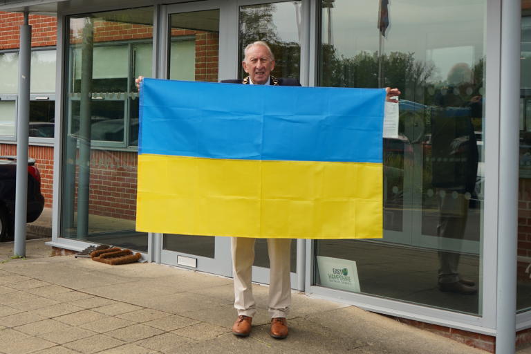 Councillor Graham Hill holding the Ukraine flag