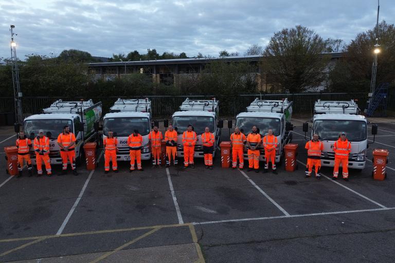 Food waste crews next to vehicles